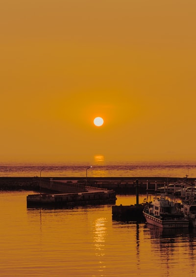 At sunset the outline of ships at sea
